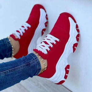 Red lace-up sneakers with chunky white soles and white laces.
