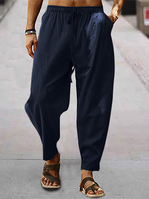 Men's navy blue drawstring wide leg sweatpants with pockets.