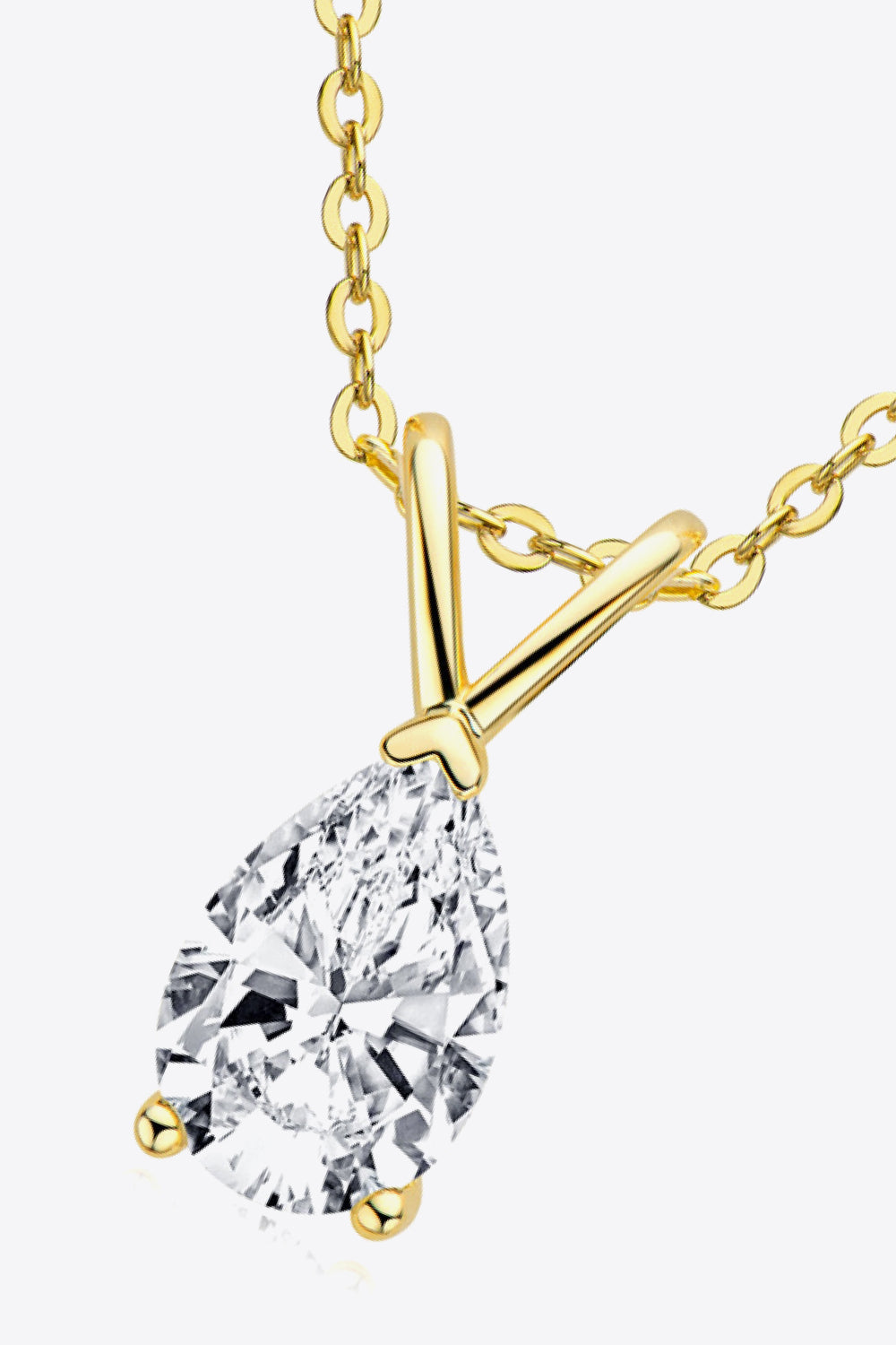 Gold pear cut moissanite pendant necklace with delicate chain.