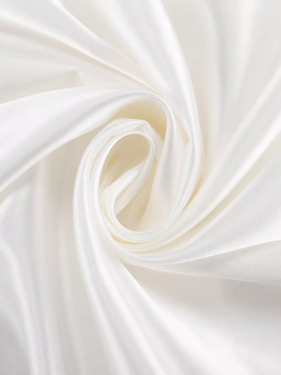 White satin fabric with soft folds and a subtle sheen
