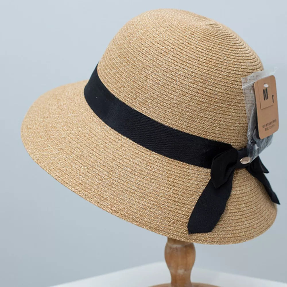 Straw bucket hat in Dust Storm with black ribbon and bow detail