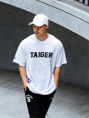 White mesh oversized t-shirt with black TAIGER graphic and short sleeves.