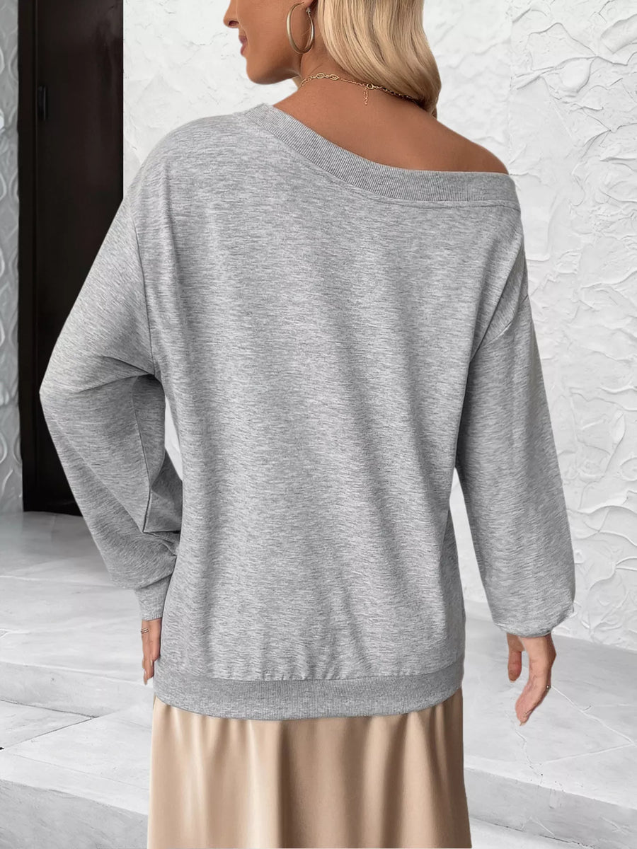 Gray boat neck sweater with long sleeves and a relaxed fit.