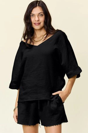 Black cotton textured half sleeve top and drawstring shorts set.