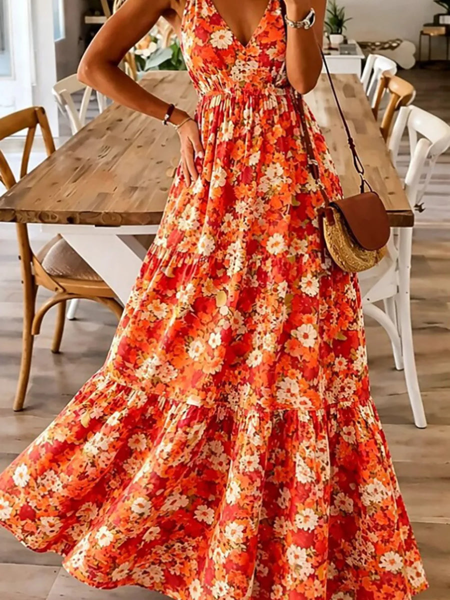 Orange floral tiered maxi dress with spaghetti straps and a V-neck.
