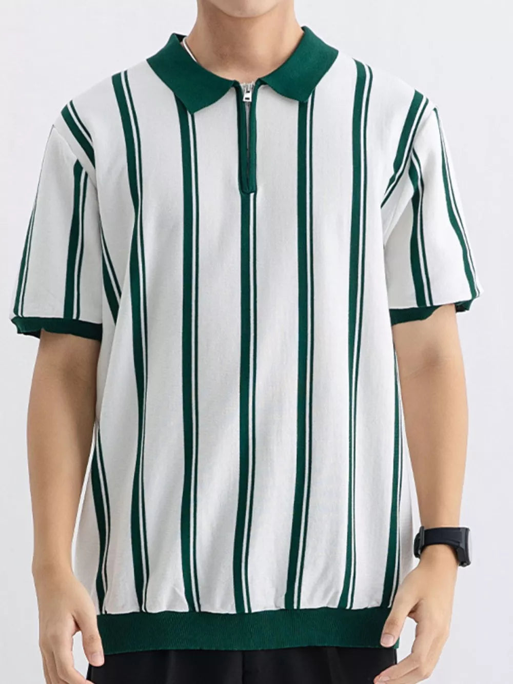 Men's white cotton polo with green vertical stripes and quarter-zip neckline.