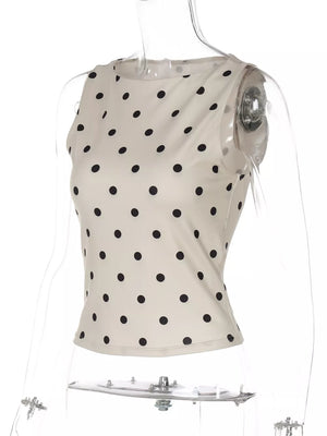 Chic polka dot tank top in cream with black dots, cropped length, and sleeveless design.