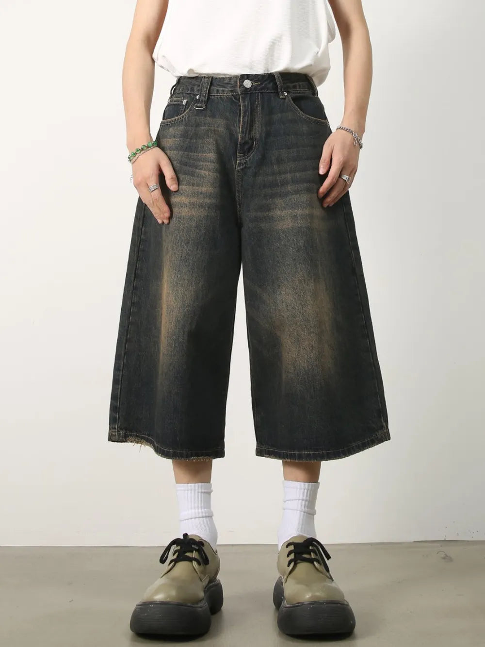 Wide-leg distressed denim culottes in dark wash with frayed hem.