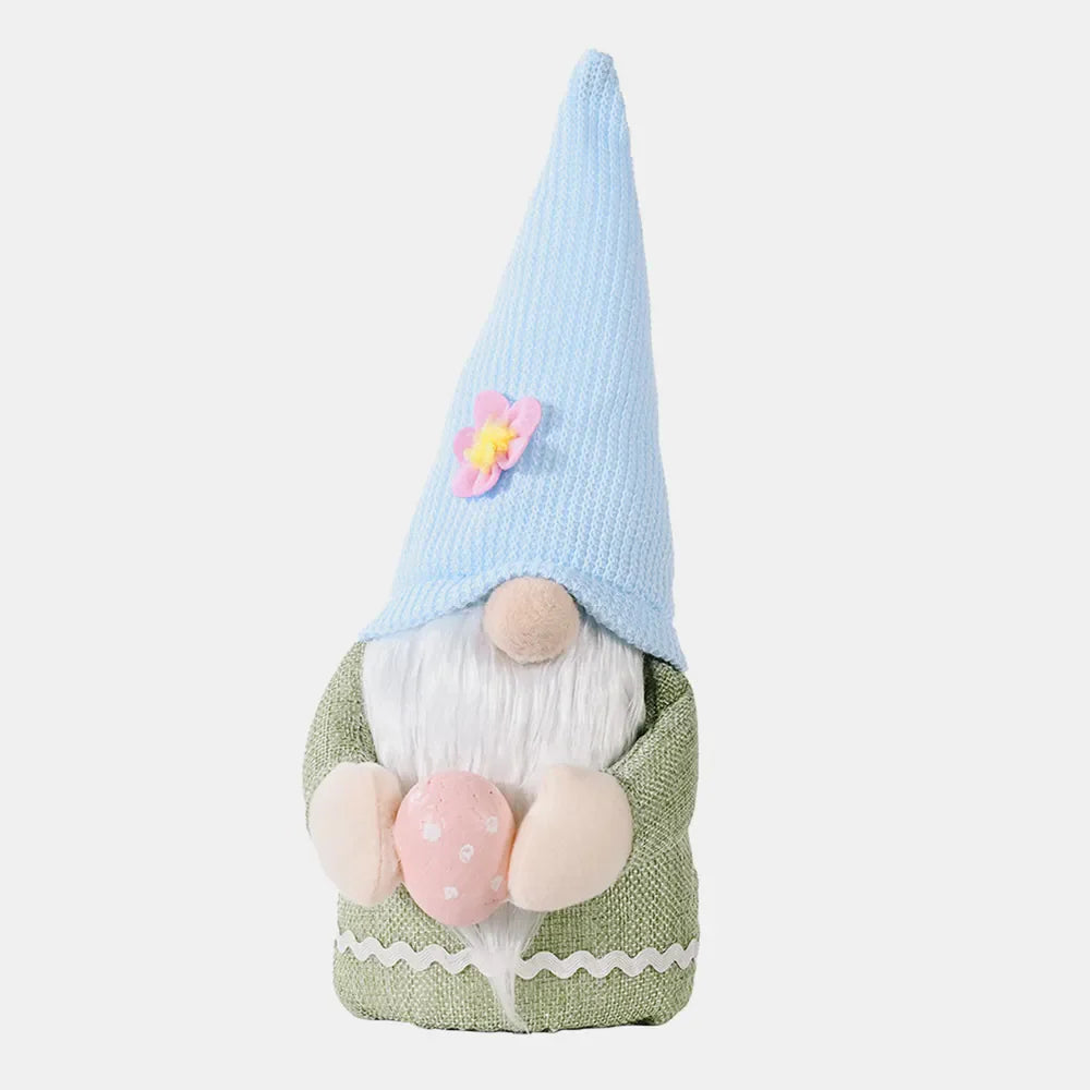 Bunny ear gnome decoration in green with pink egg and blue hat with flower.