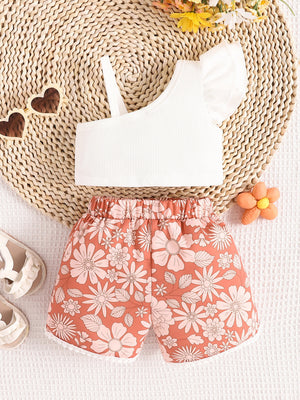 White asymmetrical top with ruffled sleeve and floral print shorts set