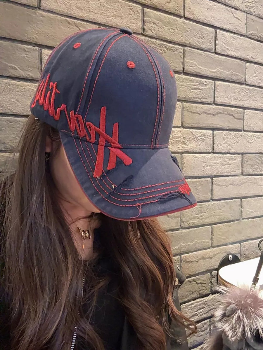 Navy cotton baseball cap with red embroidery and contrast stitching.