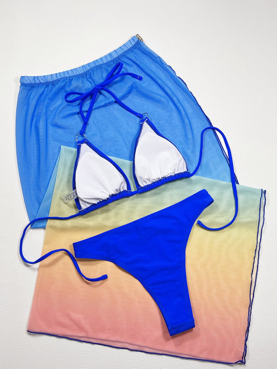 Royal blue bikini set with white lined cups and a sheer ombre sarong skirt with a drawstring waist.