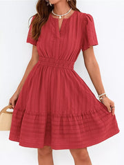 Red textured V-neck tiered dress with smocked waist and short sleeves.