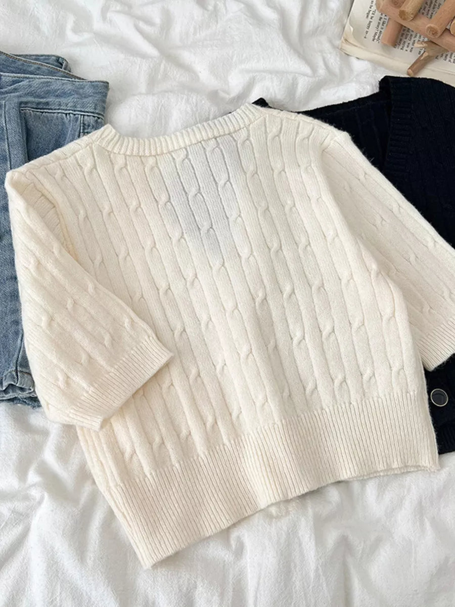 White cable-knit cropped cardigan with button detail, acrylic.
