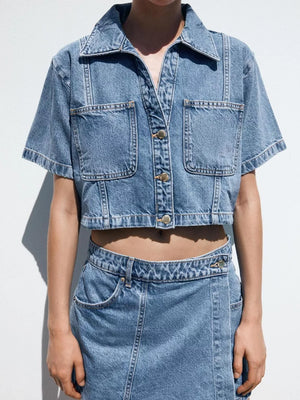 Denim cropped button-up top and skort set in dark blue with contrast stitching and pockets.
