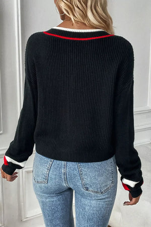 Black V-neck sweater with red and white striped trim on neckline and cuffs.
