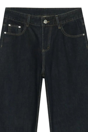 Dark denim exaggerated wide leg trousers with visible stitching and button fly.