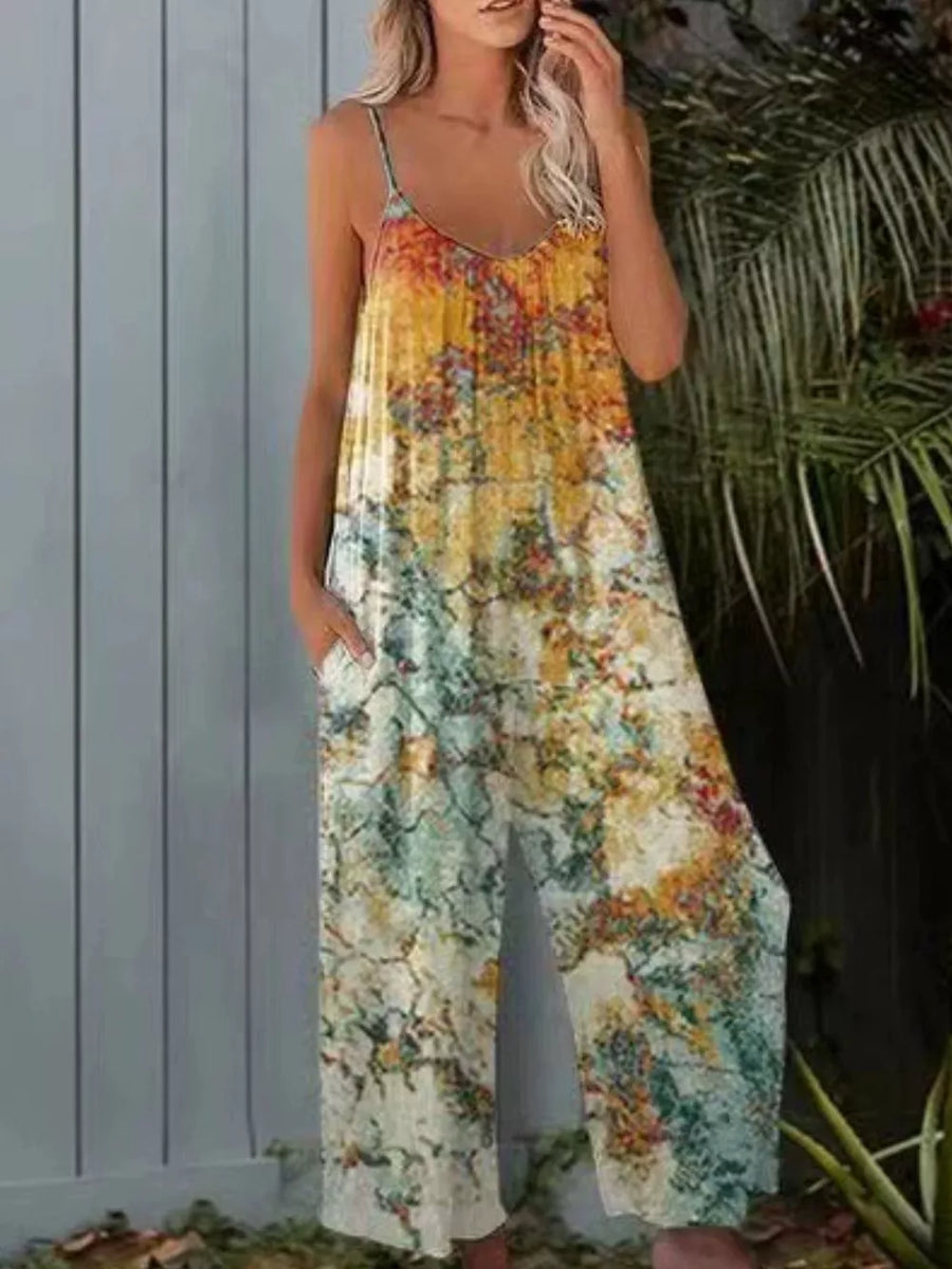 Women's wide leg jumpsuit with abstract print, V-neck, spaghetti straps and side pockets.