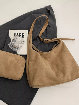 Brown suede hobo bag with adjustable strap and matching pouch.