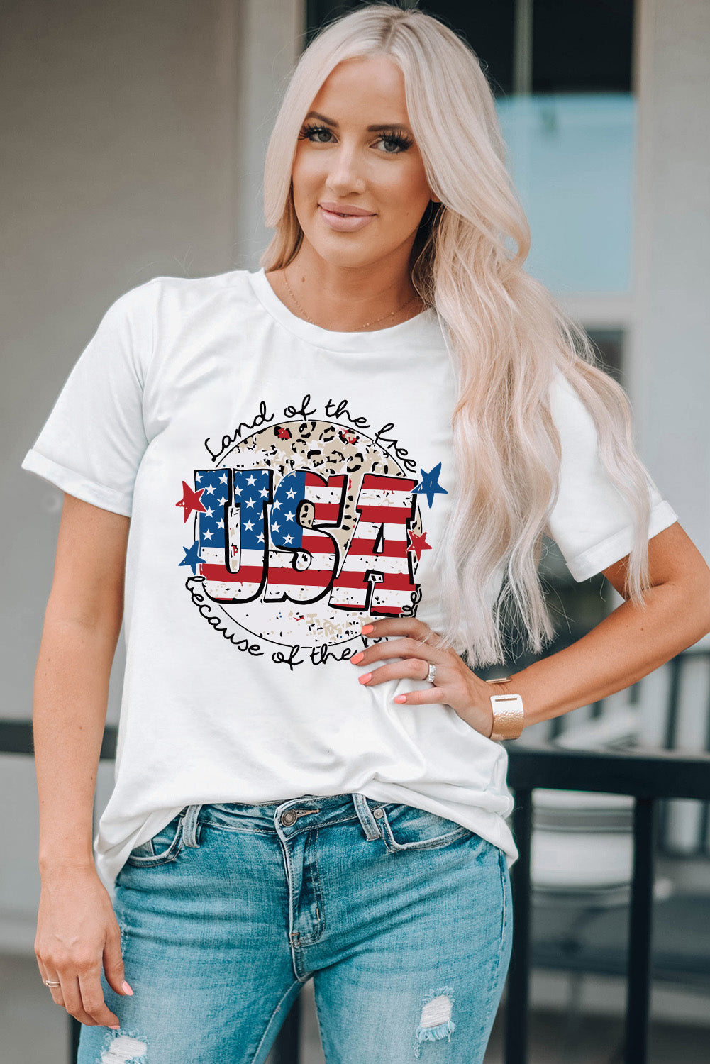 White graphic tee with USA flag design, leopard print, and patriotic text.