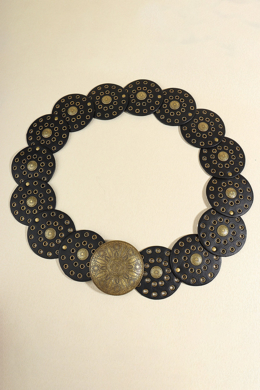 Black leather belt with embossed medallions and studded details