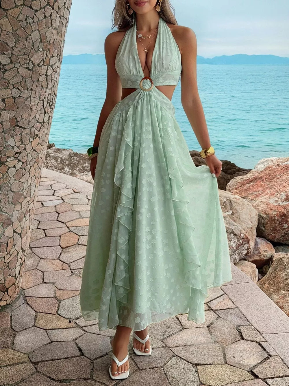 Textured ruffled halter neck maxi dress with cutouts and ring detail in light green.