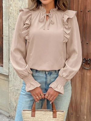 Chic beige long sleeve shirt with ruffled neckline and tie, smocked cuffs