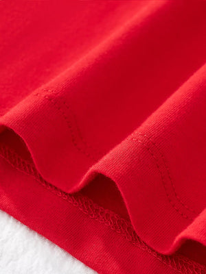 Red cotton t-shirt detail showing hem stitching and fabric texture