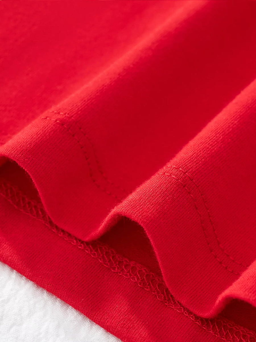 Red cotton t-shirt detail showing hem stitching and fabric texture