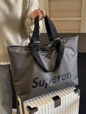 Spacious grey Oxford cloth travel shoulder bag with black "Superen" logo and black straps.
