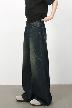 Faded wash dark denim palazzo jeans with a relaxed fit and wide leg.