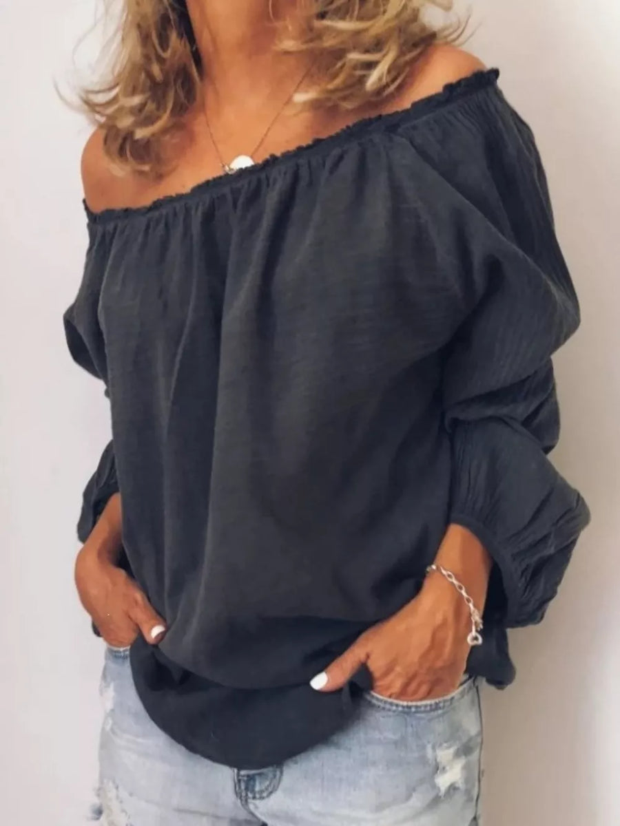 Gray off-the-shoulder maternity shirt with gathered neckline frill detail and billowy sleeves.