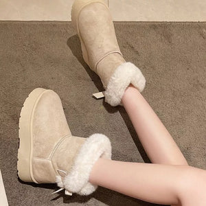Beige suede round-toe boots with white fur trim and a platform sole.