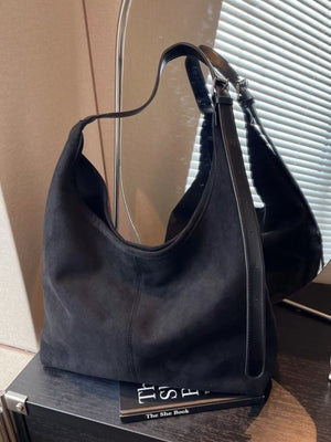 Black suede hobo bag with adjustable strap and leather trim