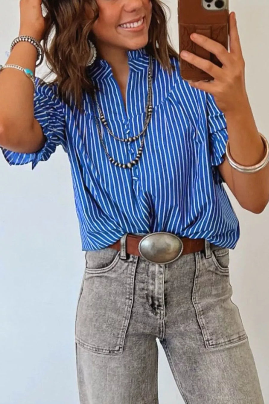 Blue striped cotton blend shirt with ruffled puff sleeves and button placket.
