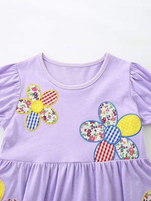 Lavender cotton toddler dress with whimsical floral appliqué and ruffled hem.