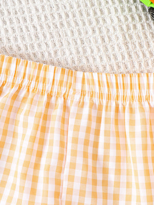 Baby shorts with yellow and white gingham pattern and elastic waistband