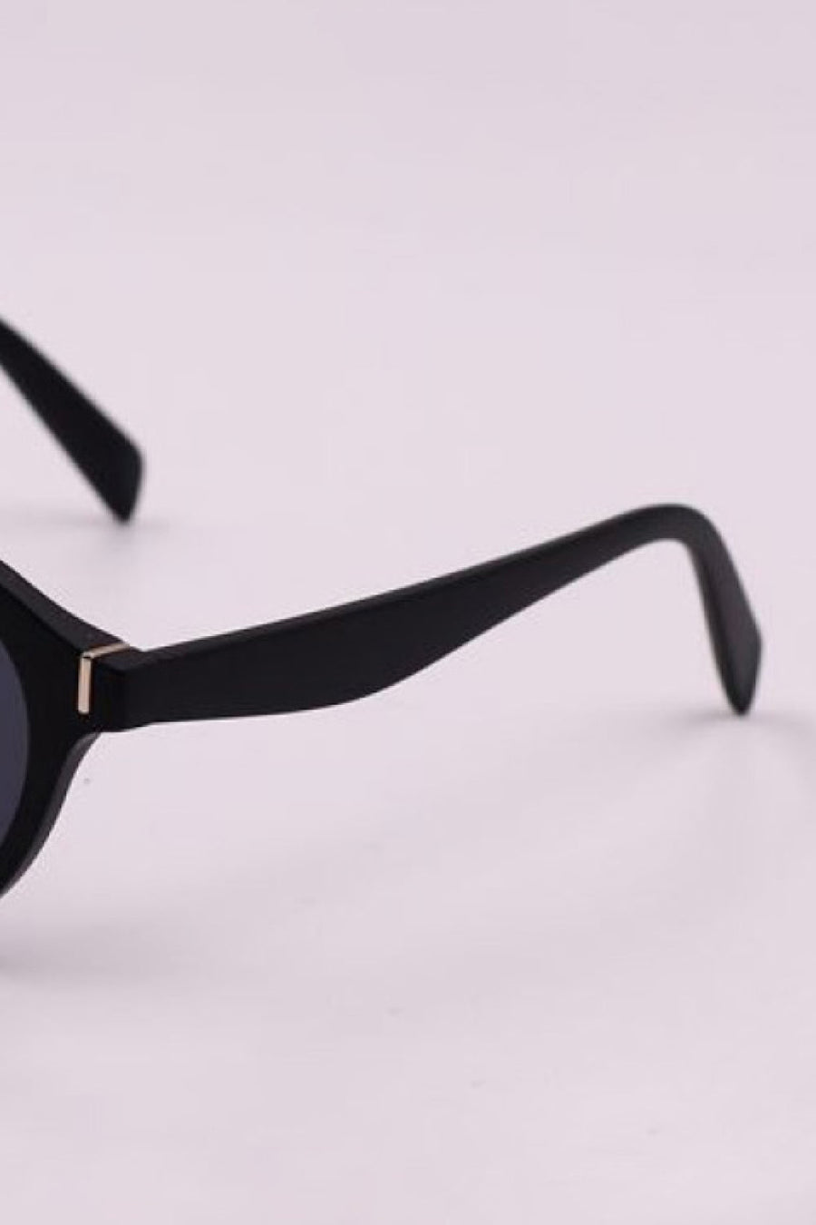 Black round frame sunglasses with gold accent detail on temple