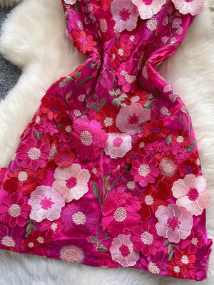 Embroidered floral mini dress in vibrant pink with 3D flower appliques and bow detail.