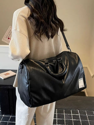 Black pu leather travel bag with top handles and adjustable shoulder strap