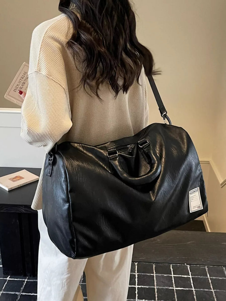 Black pu leather travel bag with top handles and adjustable shoulder strap