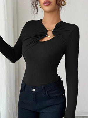 Black long-sleeve tee with asymmetrical cutout and gold ring detail.