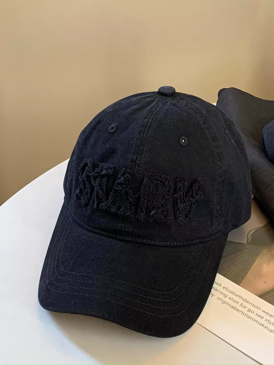 Black cotton baseball cap with distressed applique letters
