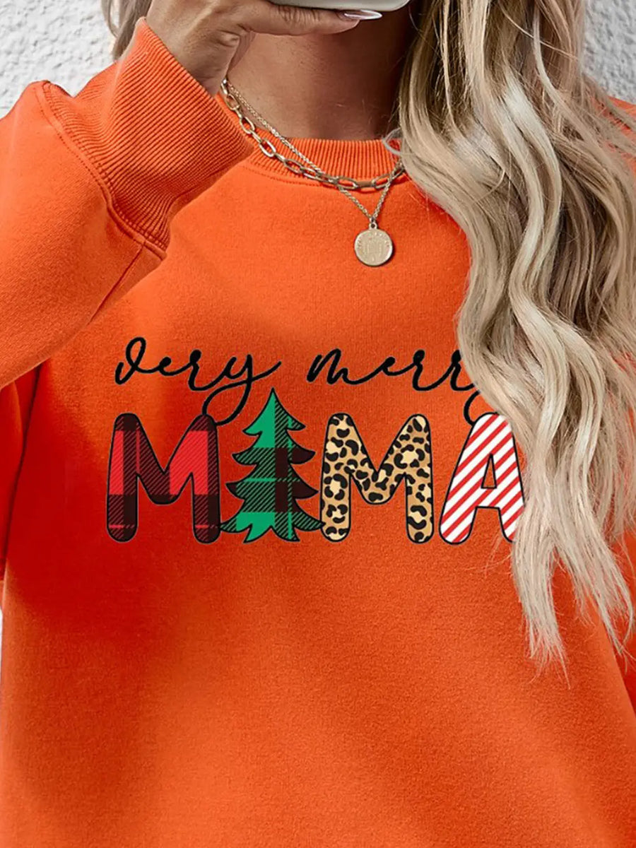 Orange long sleeve sweater with "Very Merry Mama" graphic in plaid, tree, leopard print, and stripes.