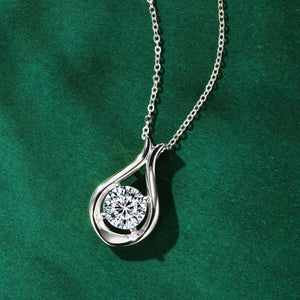 Silver teardrop pendant necklace with a round moissanite stone.