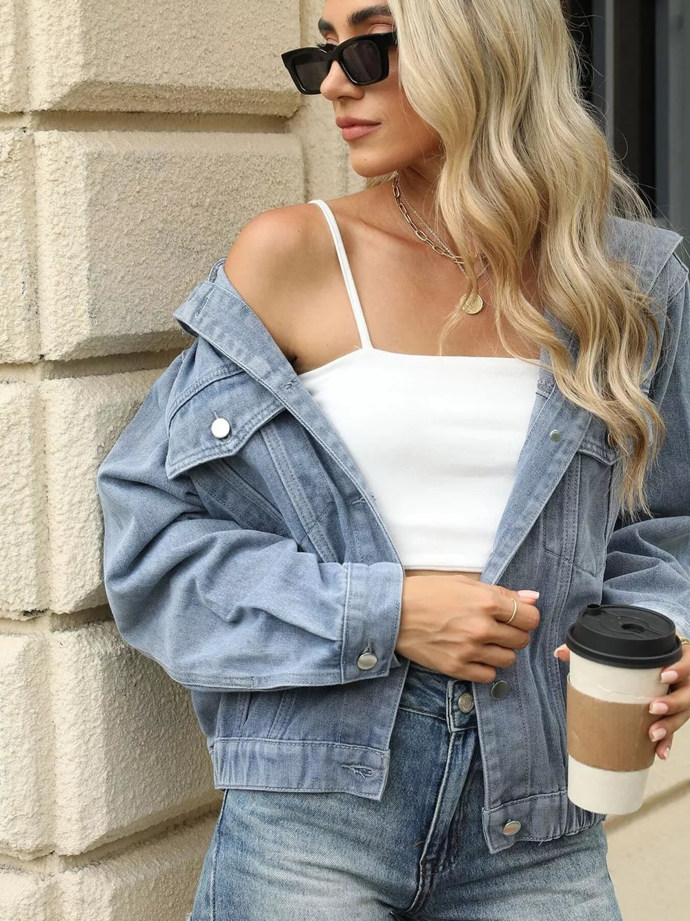 Blue denim jacket with hood, button-up front, chest pockets, and relaxed fit.