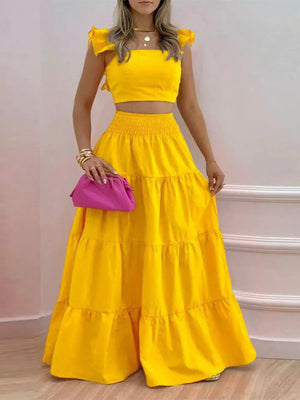 Yellow ruffled crop top and tiered maxi skirt set with smocked waist.