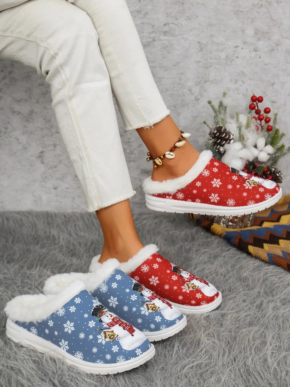 Snowman print sherpa lined holiday slides in red and blue with white snowflakes.