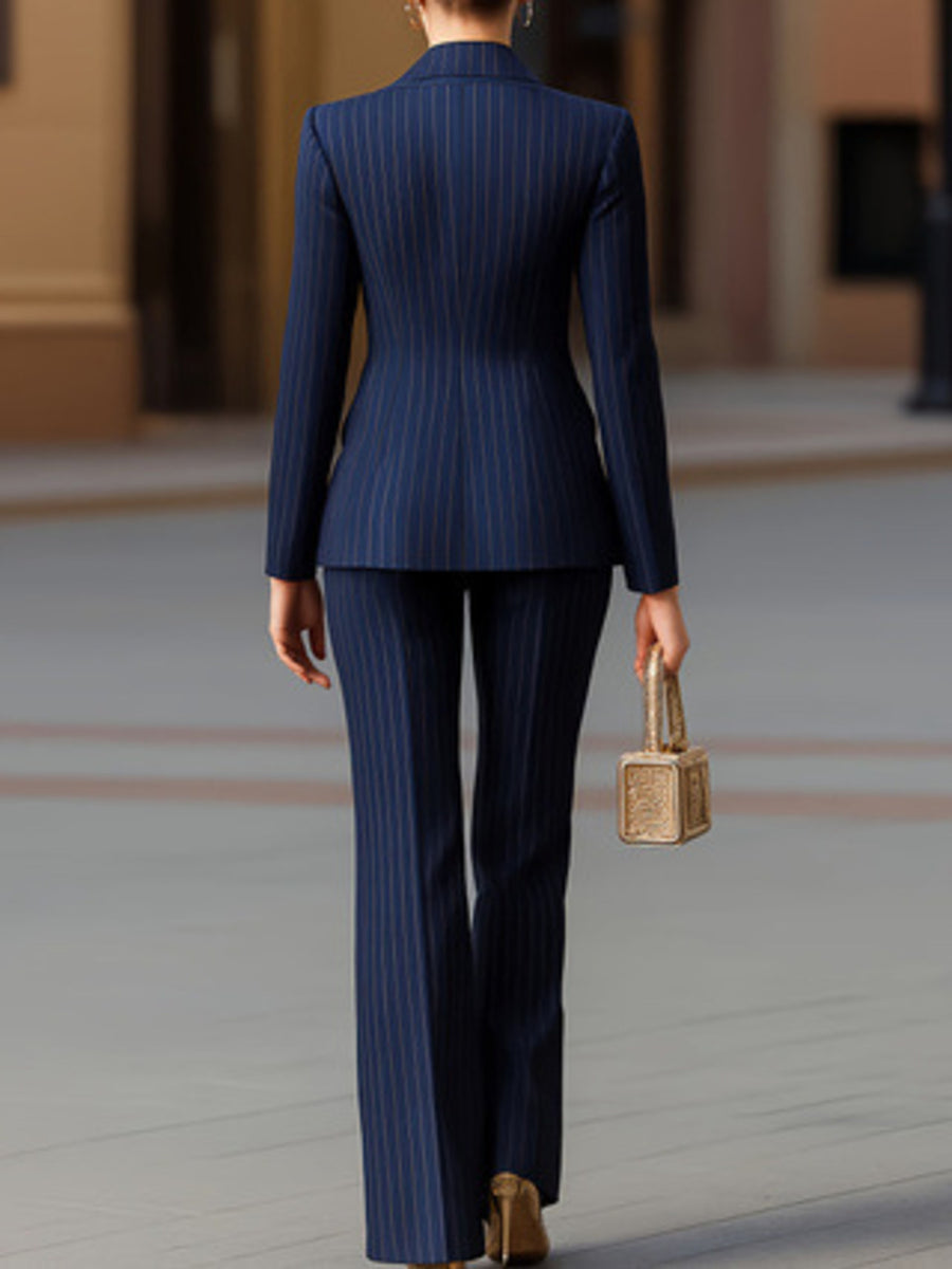 Navy pinstripe blazer and wide-leg pants set with button detail.