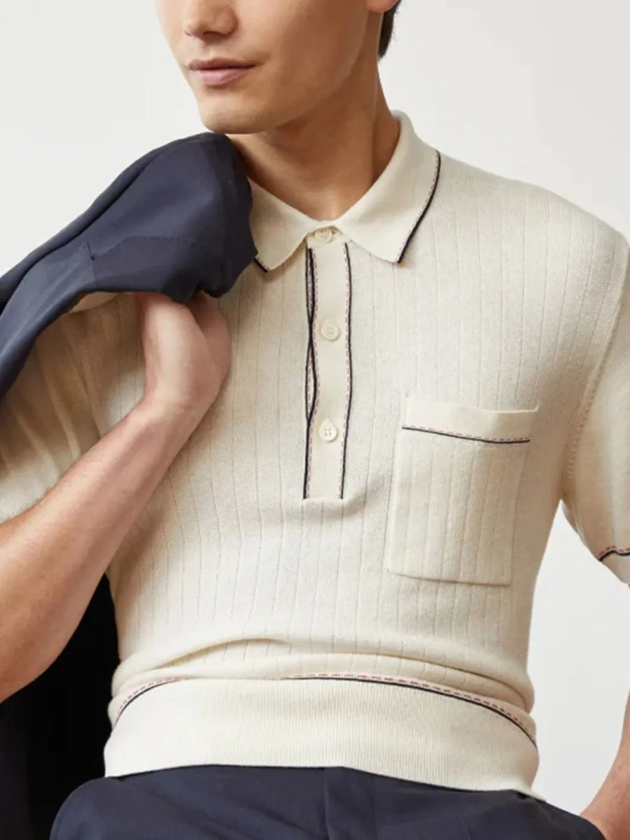 Ivory ribbed knit polo shirt with contrast piping and chest pocket.